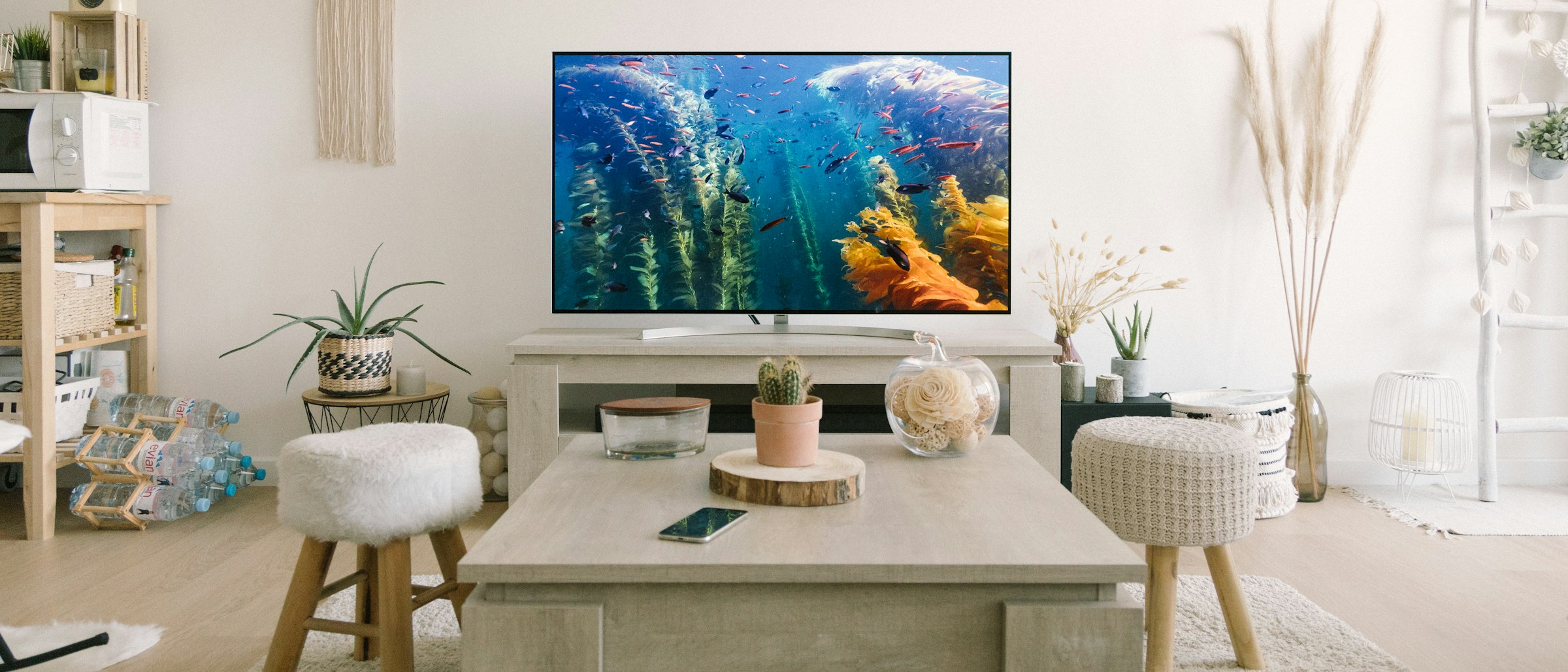 Salon lumineux avec une télévision posée sur un meuble bas